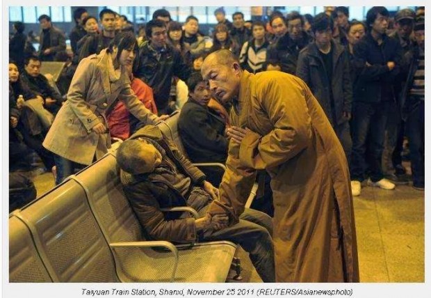 A-monk-prays-for-a-dead-man-in-the-station-hall-of-the-Shanxi-Taiyuan-Train-Station-China