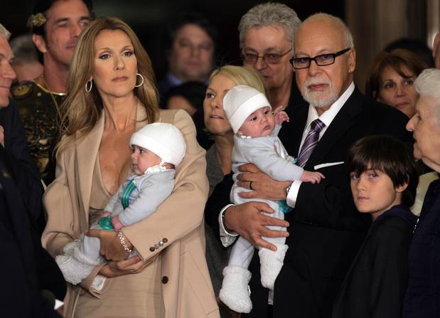 Celine Dion arrives at Caesars Palace with her husband and sons in Las Vegas, Nevada February 16, 2011. Dion is holding her son Nelson. Her husband Rene Angelil is holding twin brother Eddy. Their son Rene-Charles is in front of his father at lower right. The singer begins a new series of shows in Las Vegas on March 15. REUTERS/Steve Marcus (UNITED STATES - Tags: ENTERTAINMENT)